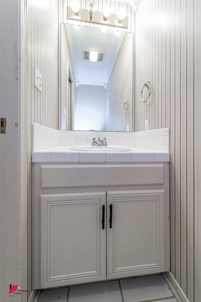 bathroom featuring tile patterned flooring and vanity