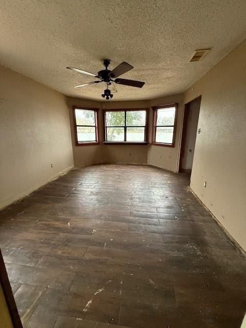 empty room featuring a textured ceiling and ceiling fan