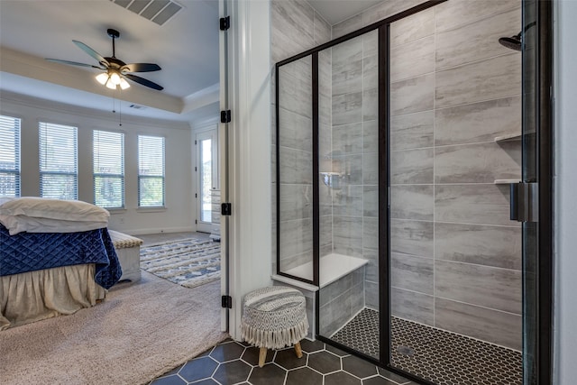 bathroom with ceiling fan, a shower with shower door, and ornamental molding