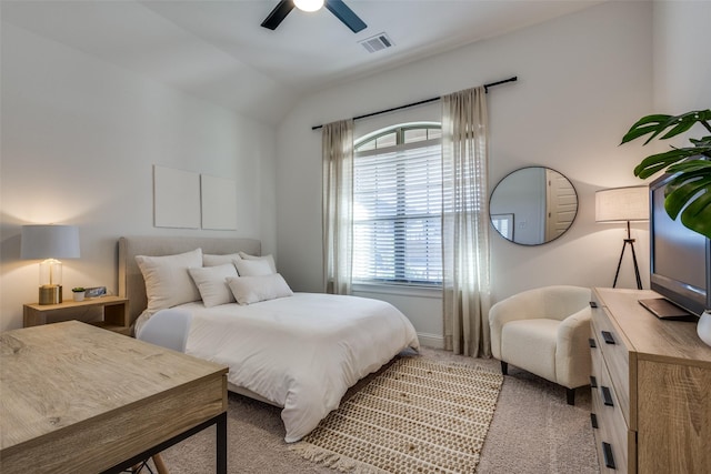 bedroom with ceiling fan, light colored carpet, and vaulted ceiling