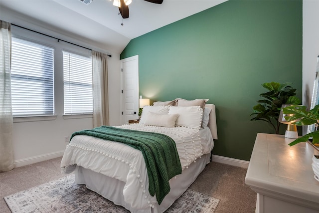 bedroom featuring multiple windows, carpet flooring, vaulted ceiling, and ceiling fan