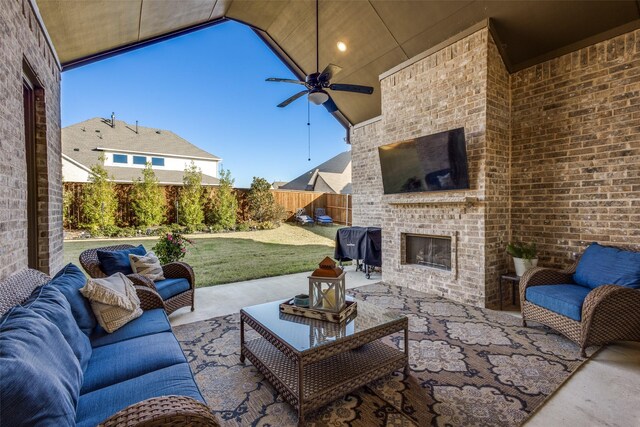 view of patio / terrace featuring an outdoor brick fireplace and ceiling fan