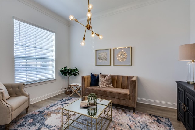 living room with crown molding, dark hardwood / wood-style floors, and an inviting chandelier