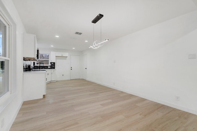 unfurnished living room with light hardwood / wood-style flooring