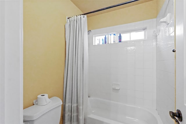 bathroom with shower / bath combination with curtain and toilet