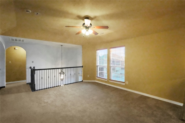 unfurnished room with ceiling fan and carpet