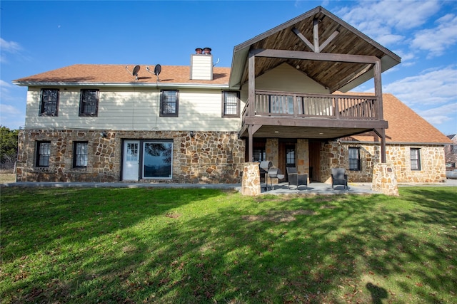 rear view of house with a lawn, a patio area, and a deck