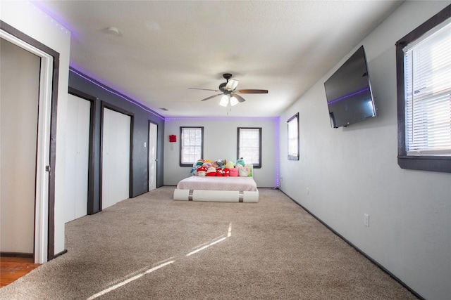 bedroom featuring ceiling fan and carpet