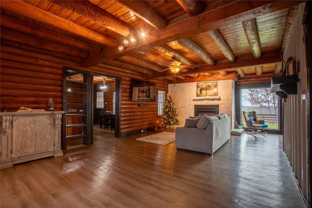 unfurnished living room with beam ceiling, rustic walls, and wooden ceiling