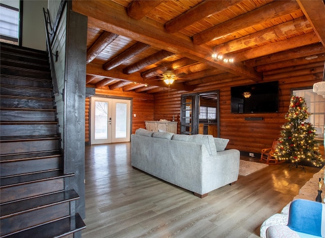 living room featuring french doors, ceiling fan, log walls, wooden ceiling, and hardwood / wood-style floors