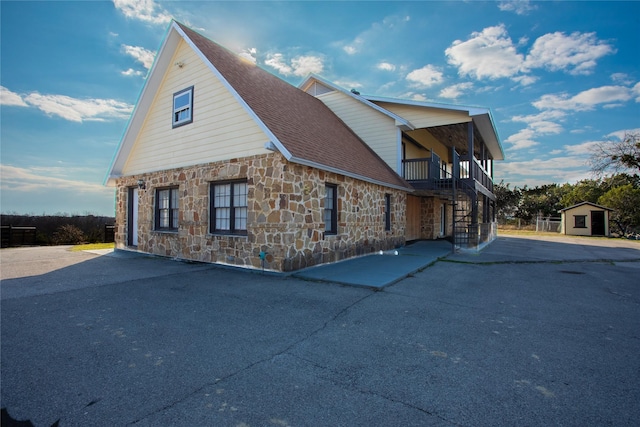 view of side of home featuring a storage unit