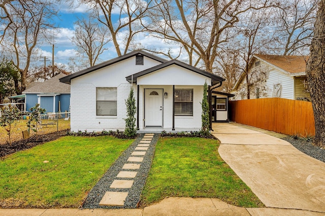 bungalow-style home with covered porch and a front yard