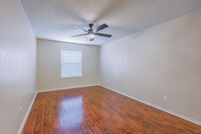 empty room featuring a textured ceiling, dark wood-type flooring, and ceiling fan