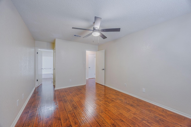 unfurnished bedroom featuring dark wood-type flooring, ceiling fan, and a textured ceiling