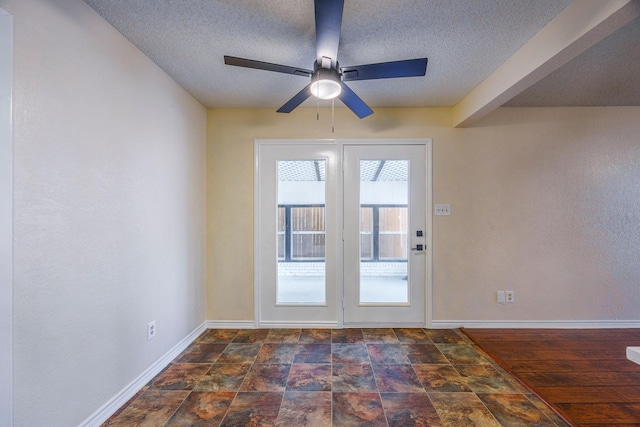 entryway featuring ceiling fan and a textured ceiling