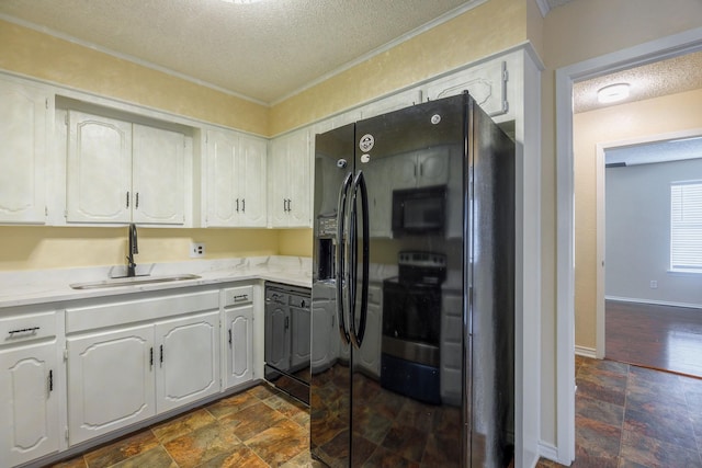 kitchen featuring a textured ceiling, sink, stainless steel electric range, and white cabinets