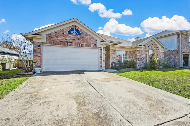 view of front of house with a garage, central AC, and a front yard