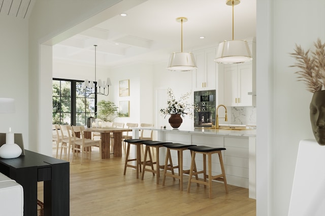 kitchen featuring built in microwave, decorative backsplash, light wood-style floors, white cabinets, and coffered ceiling