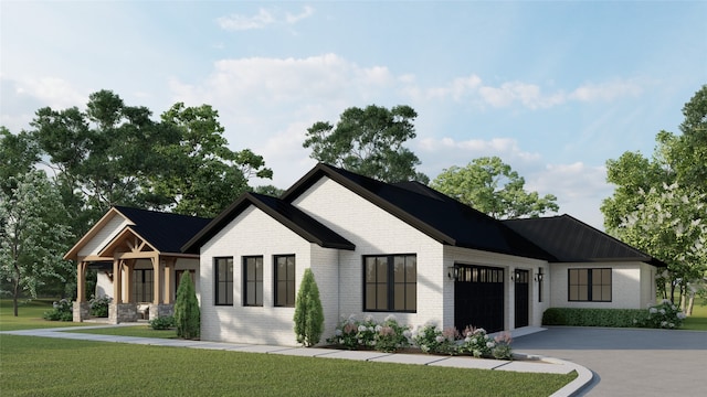 modern farmhouse style home with brick siding, a front lawn, concrete driveway, and an attached garage