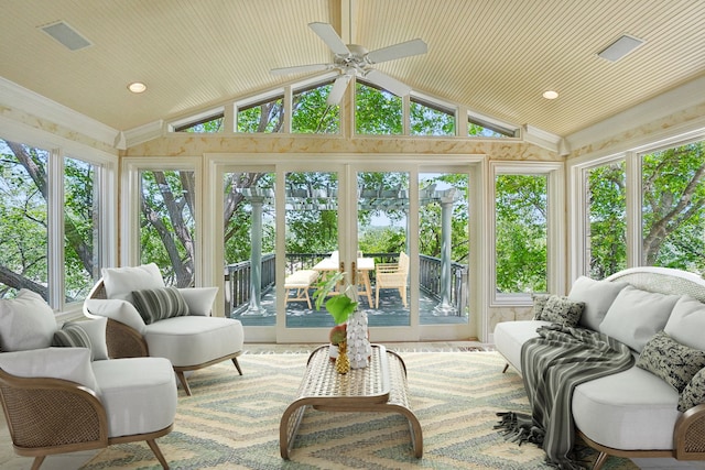 sunroom / solarium featuring lofted ceiling, ceiling fan, and a healthy amount of sunlight