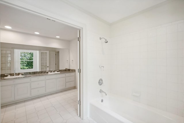 bathroom featuring tile patterned floors, vanity, and tiled shower / bath