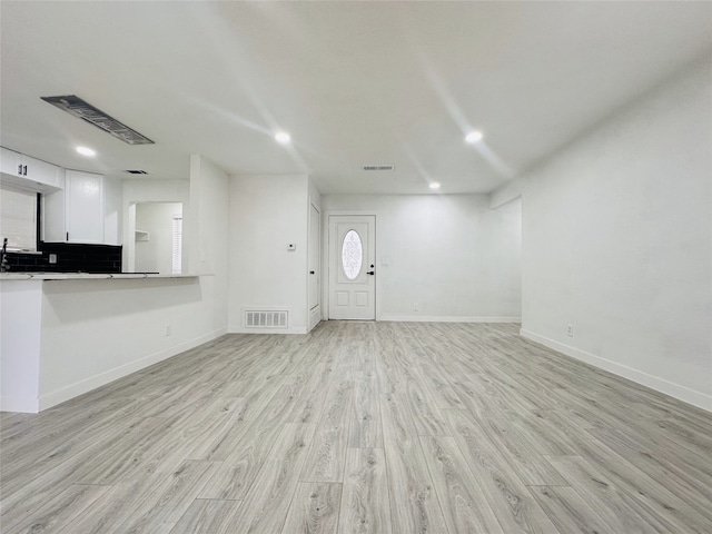 unfurnished living room featuring light hardwood / wood-style floors