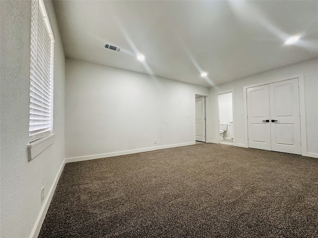 unfurnished bedroom with carpet and a closet