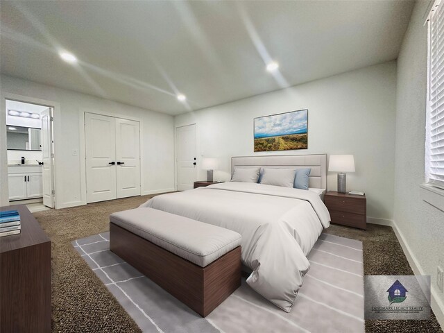 bedroom featuring dark colored carpet, a closet, sink, and ensuite bath