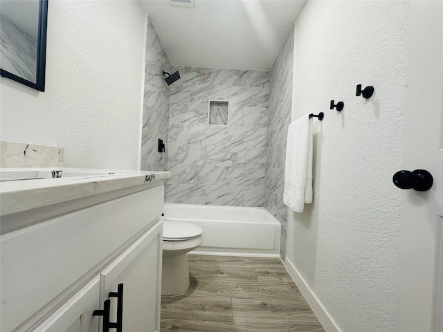 full bathroom with wood-type flooring, vanity, toilet, and tiled shower / bath combo