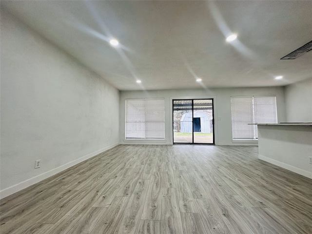 unfurnished living room with light wood-type flooring