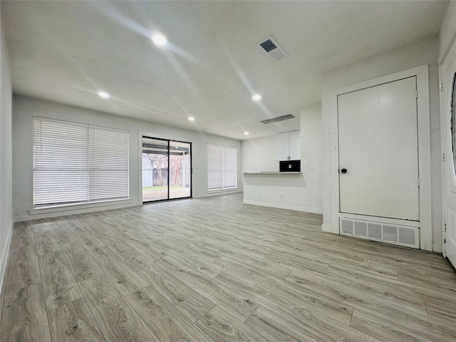 unfurnished living room featuring light hardwood / wood-style floors