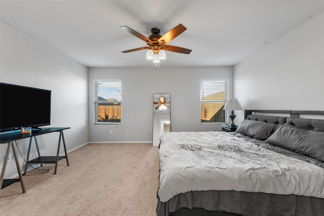 carpeted bedroom featuring multiple windows and ceiling fan