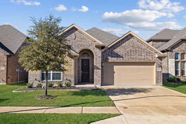 view of front of property with a garage and a front yard