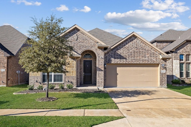 view of front of home with a garage and a front yard