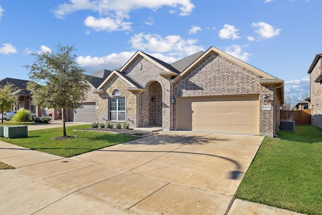 view of front of property with a garage and a front lawn