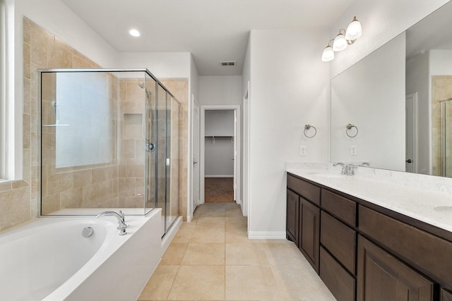 bathroom featuring plus walk in shower, tile patterned floors, and vanity