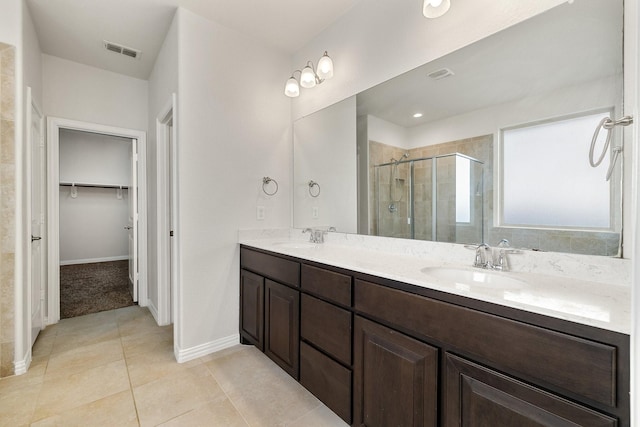 bathroom featuring vanity, an enclosed shower, and tile patterned flooring