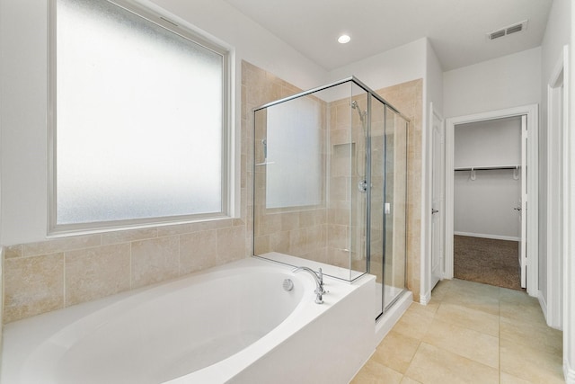 bathroom featuring separate shower and tub and tile patterned flooring