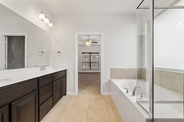 bathroom featuring a bathing tub, tile patterned floors, ceiling fan, and vanity