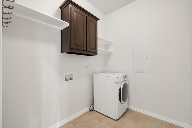 laundry room with light tile patterned floors, washer / dryer, and cabinets