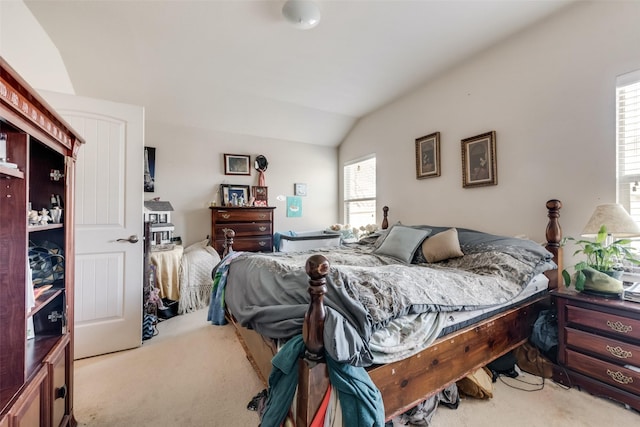 bedroom featuring light carpet and lofted ceiling