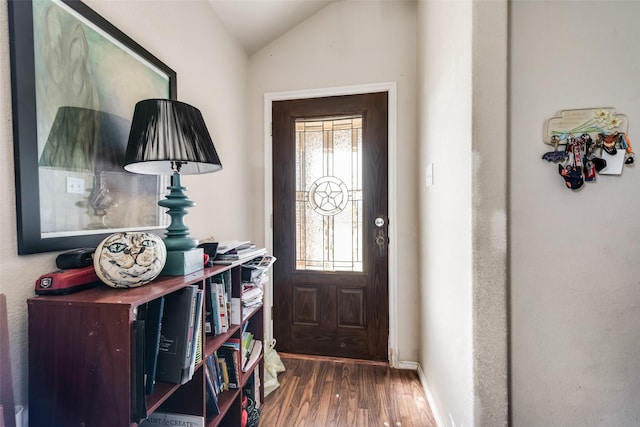 foyer featuring dark hardwood / wood-style floors and lofted ceiling