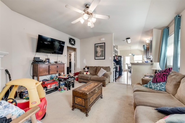 living room featuring ceiling fan and vaulted ceiling