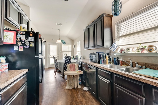 kitchen featuring dark hardwood / wood-style flooring, vaulted ceiling, sink, black appliances, and pendant lighting