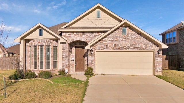 view of front of house featuring a garage and a front lawn