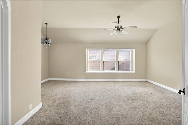 empty room featuring vaulted ceiling, carpet flooring, and ceiling fan