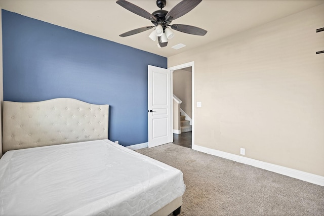 bedroom with ceiling fan and dark colored carpet