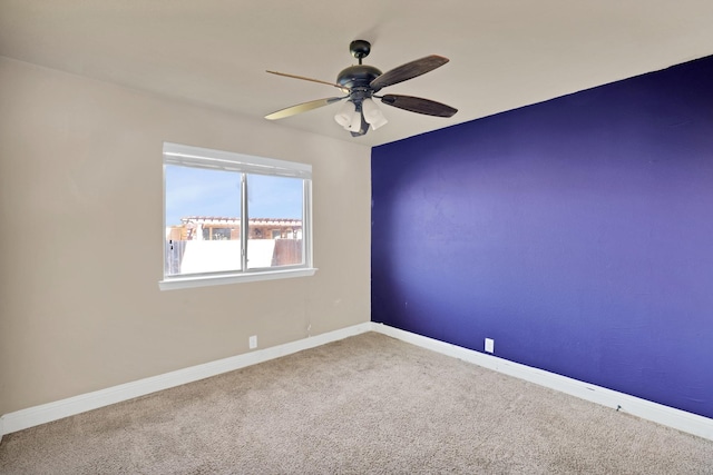 unfurnished room featuring ceiling fan and carpet floors