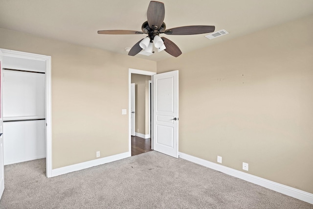 unfurnished bedroom featuring carpet flooring, ceiling fan, and a closet