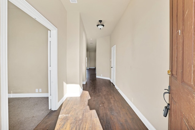 hallway with dark hardwood / wood-style flooring